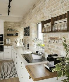 a kitchen with white cabinets and wooden counter tops