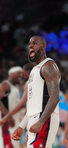 the basketball player is laughing while standing in front of other players