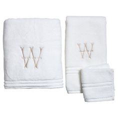 two white towels with embroidered monograms on the front and one in the back