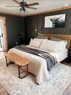 a large bed sitting in a bedroom next to a wooden bench