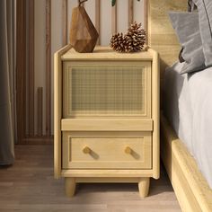 a pine cone on top of a nightstand next to a bed