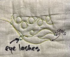 an embroidered piece with the words eye lashes on it