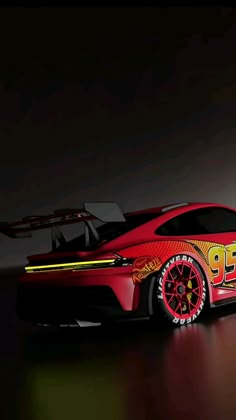 a red sports car with numbers painted on it's side, in a dark room