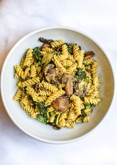 a white bowl filled with pasta and mushrooms