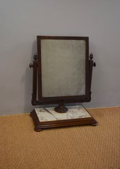 a mirror sitting on top of a wooden stand