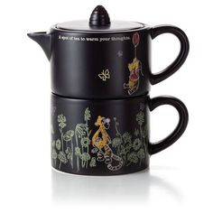 two black mugs with winnie the pooh designs on them