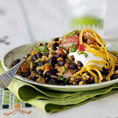 a white plate topped with black beans and rice