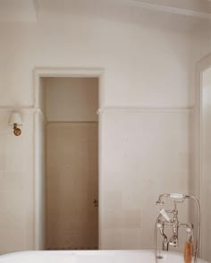 a white bath tub sitting under a bathroom window