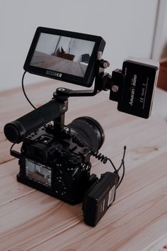 a video camera sitting on top of a wooden table