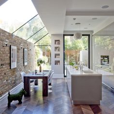 an open kitchen and dining room with brick walls