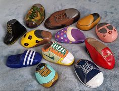 there are many pairs of shoes on the floor together, all painted in different colors