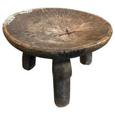 an old wooden stool that has been turned into a table with a clock on it