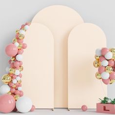 an arch is decorated with pink, white and gold balloons