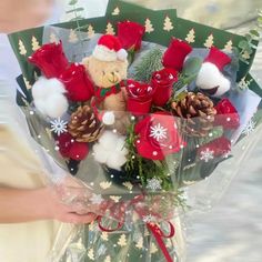 a person holding a christmas bouquet in their hand