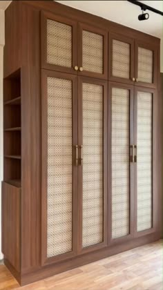 a large wooden cabinet with glass doors in a room