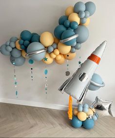 an image of a balloon decoration in the shape of a rocket ship