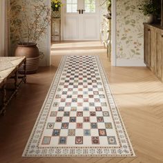 a large rug is on the floor in front of an entry way with potted plants