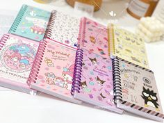 several notebooks are lined up on a table