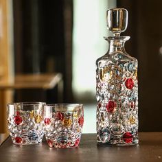 three glasses and a decanter sitting on a table