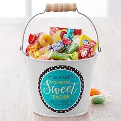 a white bucket filled with lots of candy