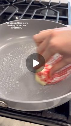 someone is using a frying pan to cook food on top of a stovetop