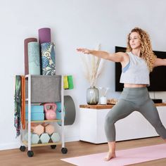 a woman is doing yoga in her living room