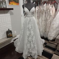 a white wedding dress on display in a store