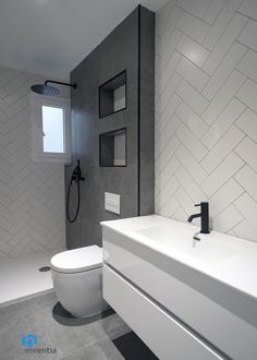 a white toilet sitting next to a sink in a bathroom