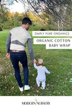 A father using The Simply Pure Organic Cotton Baby Wrap to hold their baby up while holding hands with their other child.