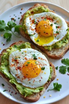 two eggs on toast with avocado and parsley sprinkled on top