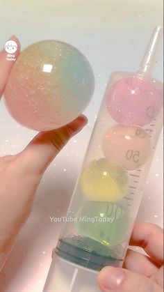 a person holding an egg in front of a test tube filled with colored liquids