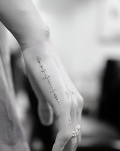 a person with a tattoo on their left hand and the word love is written in cursive writing