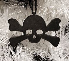 a skull and crossbone ornament hanging from a christmas tree