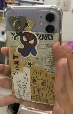 someone is holding up their phone case with stickers on it in the shape of a spiderman