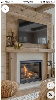 a fireplace with a flat screen tv mounted above it's mantle and fire place