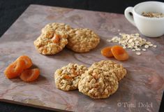 oatmeal cookies and apricots on a cutting board