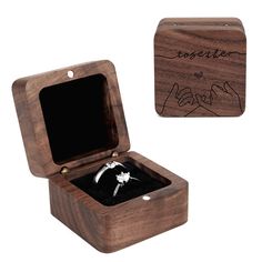 an open wooden box with a ring inside