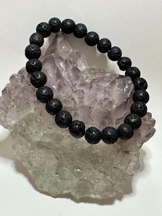 Lava Stone Bracelet: Perfect for using essential oils to diffuse the healing properties of the oil. This black lava stone has always aided in grounding one's energy, adding the essential oils will enhance the grounding and healing.  Bracelet care: Please remove your bracelets if you are going to shower and have your hands submersed in water for any length of time. Wipe them down with a soft dry cloth every so often to bring back their natural shine. Try not to wear them to bed every night as thi Casual Black Jewelry For Healing, Black Lava Stone Spiritual Bracelets, Black Holistic Beaded Bracelets With Natural Stones, Holistic Black Beaded Bracelet With Natural Stones, Black Lava Stone Spiritual Beaded Bracelets, Spiritual Lava Stone Bracelet With Black Beads, Spiritual Black Beads Lava Stone Bracelet, Black Holistic Beaded Bracelets, Black Holistic Round Beaded Bracelets