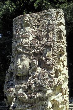 a stone statue with carvings on it's face