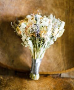 a bouquet of flowers sitting on top of a wooden chair