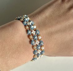 a close up of a person's arm wearing a bracelet with beads on it