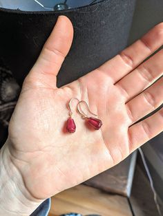 Juicy red pomegranate seed earrings 🍎 Aside from being one of the most nutritionally and antioxidant packed foods on the planet, pomegranates are highly symbolic Pomegranates symbolize fertility, fruitfulness, and prosperity. Biblically, they were a decoration to signify the sweetness of heaven, as well as adorned on the attire of the high priest 🙏🏼 These are pomegranate seed earrings. Each seed is handblown glass, and is anatomically correct. It is a deep red hue, and very translucent in the Dainty Red Dangle Jewelry, Pink Teardrop Earrings For Gift, Red Dangle Jewelry Gift For Her, Handmade Garnet Drop Earrings, Faceted Teardrop Red Jewelry, Faceted Teardrop Dangle Earrings As Gift, Faceted Teardrop Dangle Earrings For Gift, Red Garnet Dangle Earrings, Gift Teardrop Dangle Earrings With Faceted Details