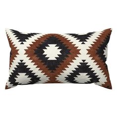 a brown and white pillow with an arrow design on the front, sitting on a white background