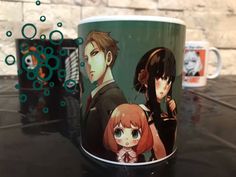 two anime mugs sitting on top of a table next to each other with bubbles