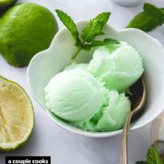 three scoops of lime ice cream in white bowls with mint leaves on the side