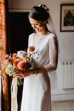 a woman in a wedding dress holding a bouquet