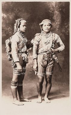 an old photo of two people in native clothing