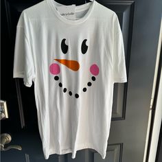 a white t - shirt with a snowman face drawn on it