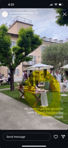 an image of people sitting at tables in the grass