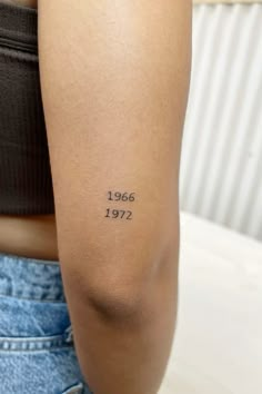 a woman with a tattoo on her arm that reads, 1965 - 1971 in black ink